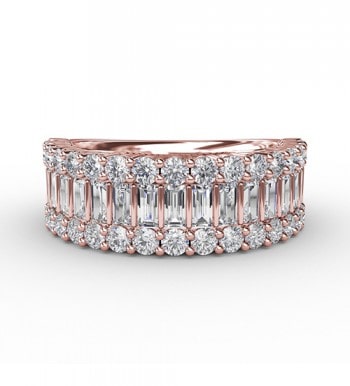A rose gold ring with small emerald cut diamonds set between layers of round diamonds