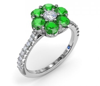 Fashion ring with green emeralds and diamonds, plus a hidden sapphire on the inset