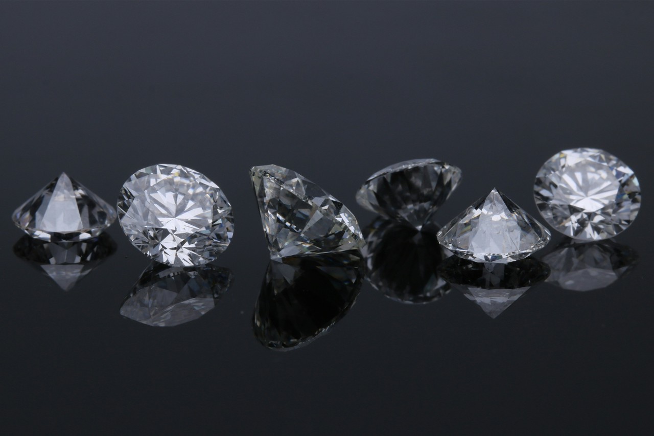 a row of diamonds on a shiny black background